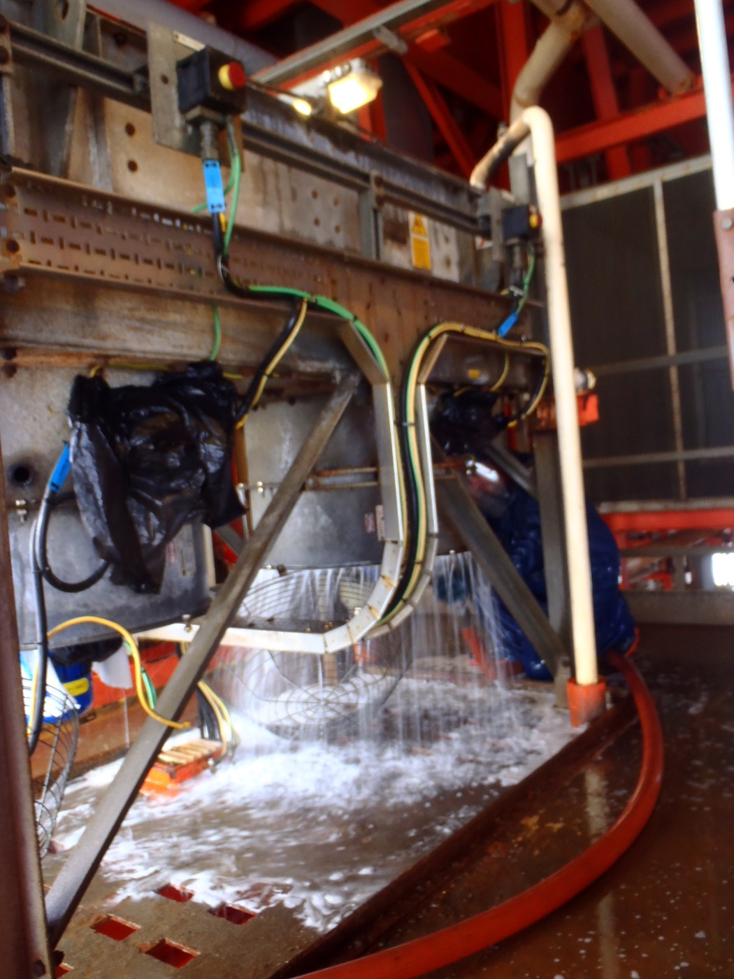 Water and foam draining from a fin fan plenum during cleaning